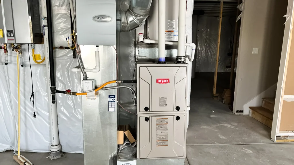 Current image: technician performing annual furnace service in Edmonton home for safety and efficiency
